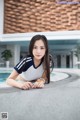 A woman laying on the edge of a swimming pool.