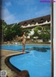 A woman standing on the edge of a swimming pool.