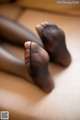 A close up of a woman's feet in black stockings.