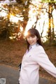 A woman in a pink sweater is posing for a picture.